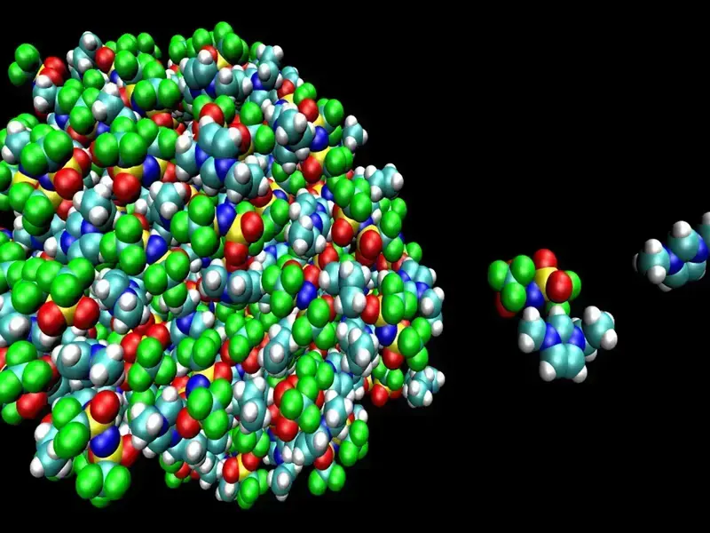 3D rendering of a large, dense molecular cluster (green, blue, white, red, yellow spheres) and smaller separate molecules.